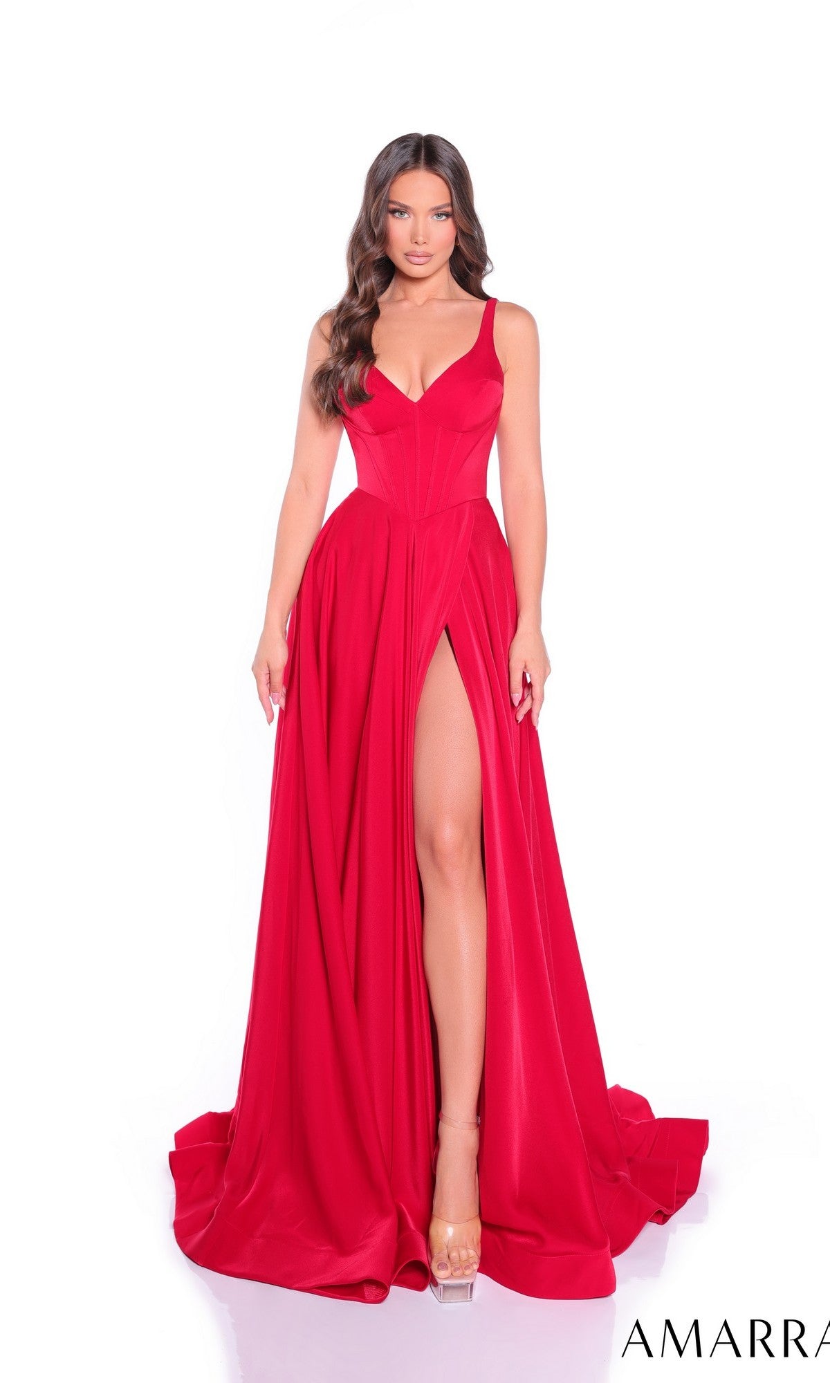 A woman models the Amarra 89519 long prom dress, featuring a sleeveless design, v-neckline, high-leg slit, fitted bodice, and flowing bright red skirt as she stands facing forward against a white background.